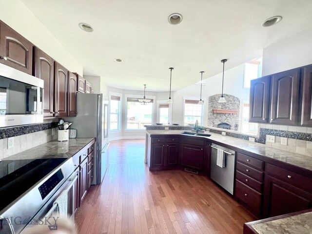 2475 Rose St, Bozeman, MT 59718 - kitchen featuring stainless steel appliances, wood-type flooring, pendant lighting, backsplash, and recessed lighting