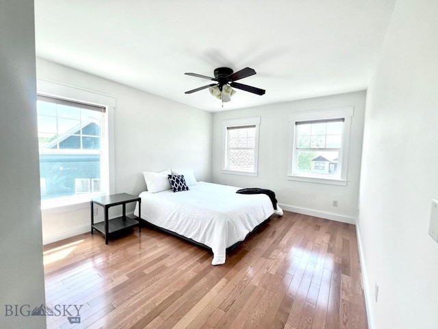 2475 Rose St, Bozeman, MT 59718 - bedroom with multiple windows, hardwood / wood-style flooring, and a ceiling fan