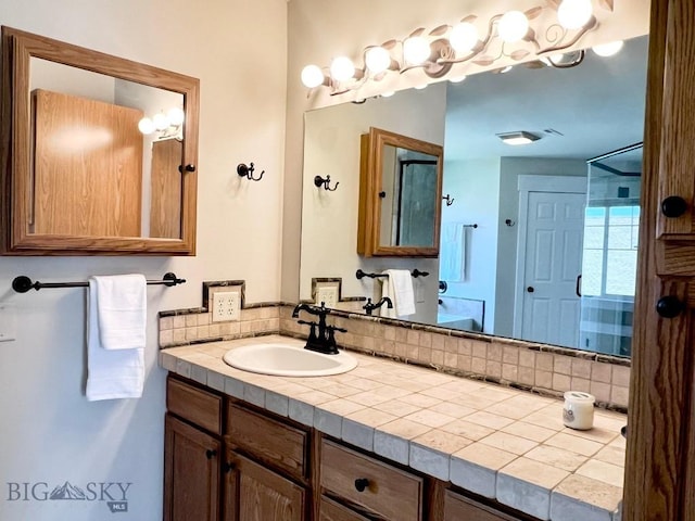 2475 Rose St, Bozeman, MT 59718 - full bathroom with vanity, backsplash, and a shower
