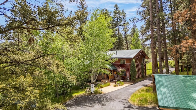 1561/1563 Colorado Gulch Dr, Helena, MT 59601 - view of property exterior with a metal roof, log exterior, and asphalt driveway