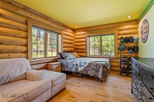 1561/1563 Colorado Gulch Dr, Helena, MT 59601 - bedroom featuring light wood-style flooring, a textured ceiling, recessed lighting, and log walls