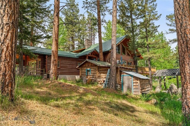 1561/1563 Colorado Gulch Dr, Helena, MT 59601 - rear view of property with log siding, a chimney, and a metal roof