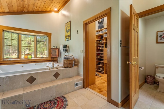1561/1563 Colorado Gulch Dr, Helena, MT 59601 - full bath featuring wooden ceiling, a bath, lofted ceiling, and tile patterned floors