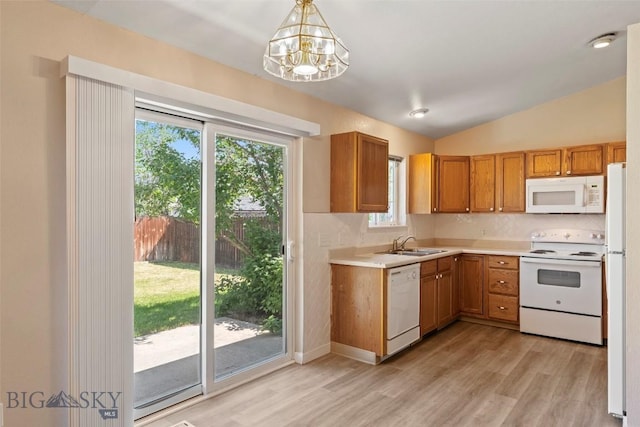 2603 Snapdragon, Bozeman, MT 59718 - kitchen with white appliances, a sink, light wood finished floors, tasteful backsplash, and lofted ceiling