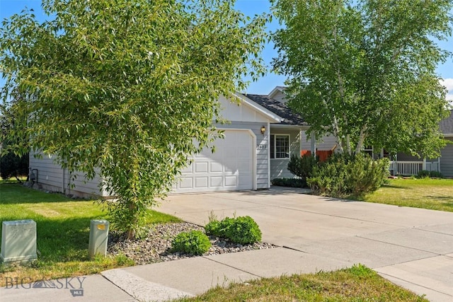 2603 Snapdragon, Bozeman, MT 59718 - obstructed view of property with driveway, an attached garage, and a front lawn