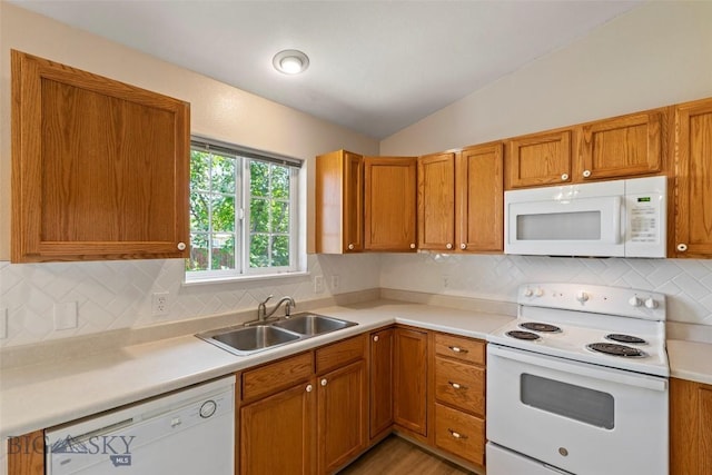 2603 Snapdragon, Bozeman, MT 59718 - kitchen featuring white appliances, a sink, lofted ceiling, light countertops, and brown cabinets