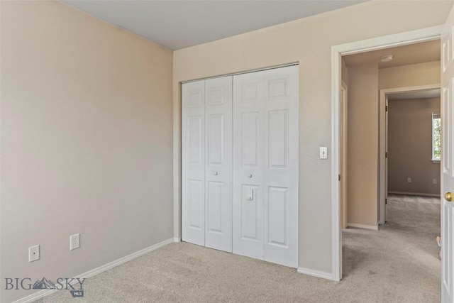 2603 Snapdragon, Bozeman, MT 59718 - unfurnished bedroom featuring light colored carpet, baseboards, and a closet