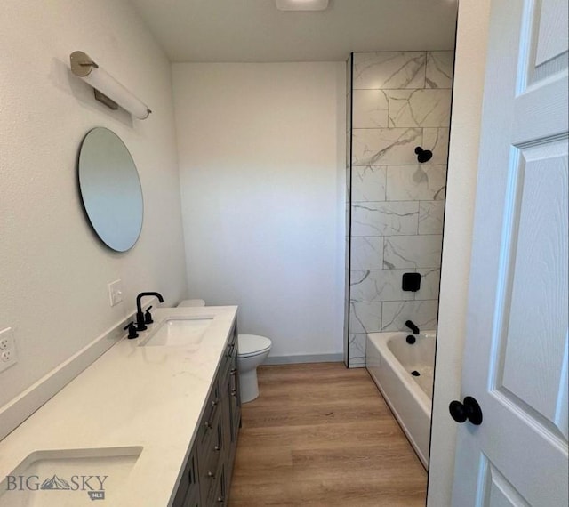 823 S Main, Butte, MT 59701 - bathroom with double vanity, toilet, wood finished floors, and tub / shower combination