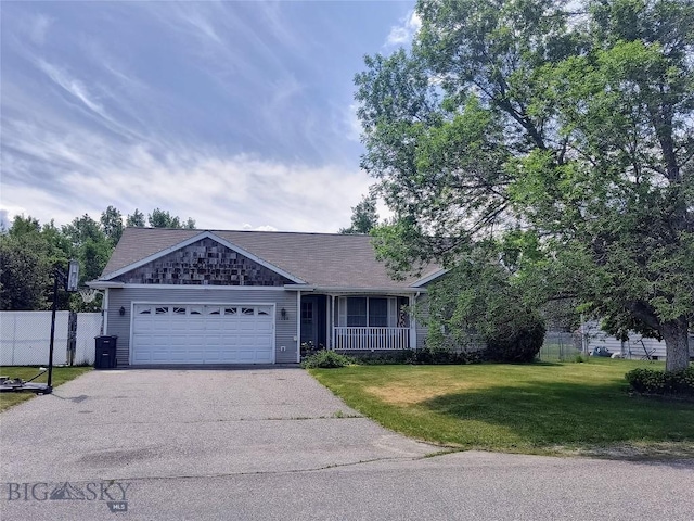 1006 E Missoula, Belgrade, MT 59714 - single story home with asphalt driveway, an attached garage, and a porch