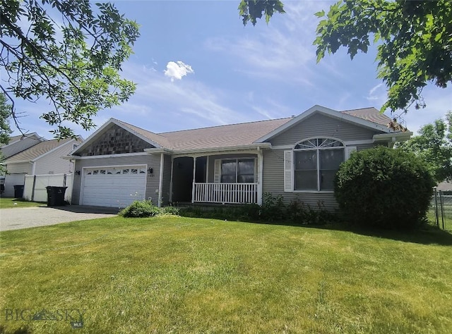 1006 E Missoula, Belgrade, MT 59714 - single story home featuring a garage, driveway, and a porch
