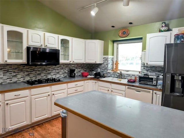 1006 E Missoula, Belgrade, MT 59714 - kitchen with black appliances, a sink, track lighting, white cabinets, and glass insert cabinets