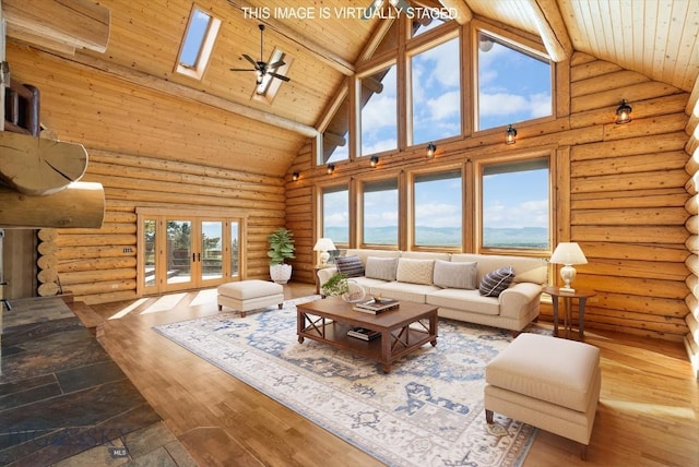 1380 Glacier View Dr, Deer Lodge, MT 59722 - living area featuring high vaulted ceiling, wooden ceiling with exposed beams, a skylight, wood finished floors, and plenty of natural light
