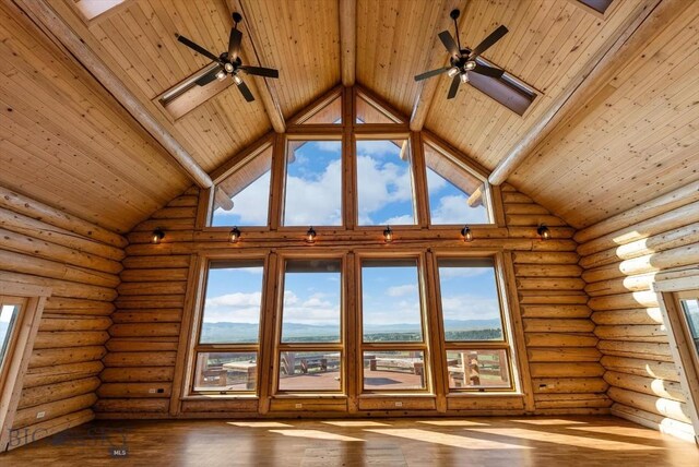 1380 Glacier View Dr, Deer Lodge, MT 59722 - spare room featuring wooden ceiling with exposed beams, high vaulted ceiling, healthy amount of natural light, hardwood / wood-style flooring, and log walls