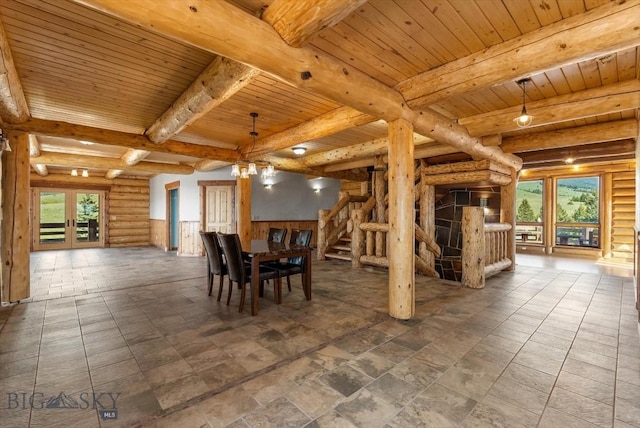 1380 Glacier View Dr, Deer Lodge, MT 59722 - dining area with rustic walls, healthy amount of natural light, wooden ceiling with exposed beams, and stairs