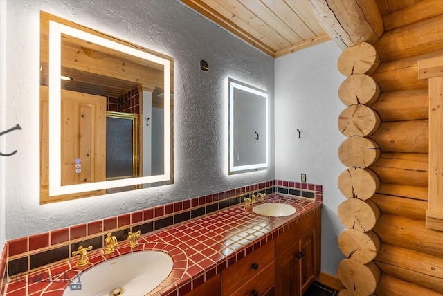 1380 Glacier View Dr, Deer Lodge, MT 59722 - bathroom with log walls, a textured wall, wood ceiling, double vanity, and a shower stall