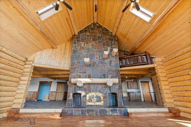 1380 Glacier View Dr, Deer Lodge, MT 59722 - unfurnished living room with wood ceiling with exposed beams, ceiling fan, high vaulted ceiling, wood finished floors, and a skylight