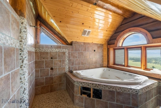 1380 Glacier View Dr, Deer Lodge, MT 59722 - bathroom with a tub with jets, lofted ceiling, wooden ceiling, and tile walls