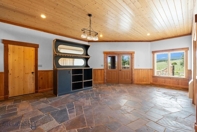 1380 Glacier View Dr, Deer Lodge, MT 59722 - unfurnished dining area with wainscoting, ornamental molding, stone tile flooring, a chandelier, and recessed lighting