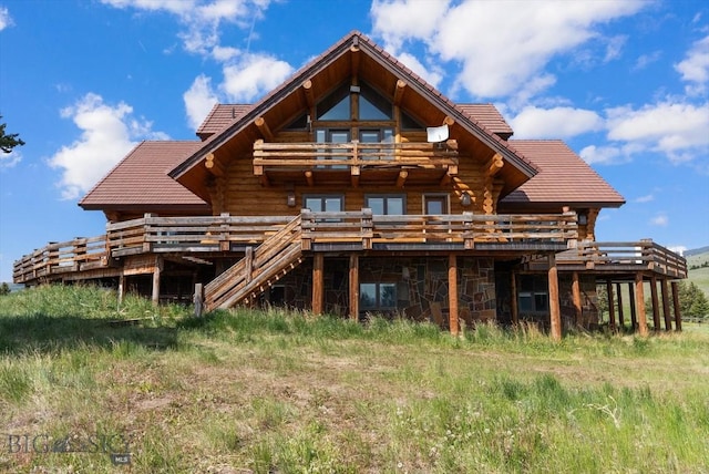 1380 Glacier View Dr, Deer Lodge, MT 59722 - rear view of house with log exterior, a tiled roof, and a wooden deck