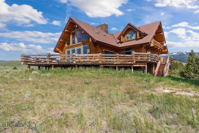 1380 Glacier View Dr, Deer Lodge, MT 59722 - rear view of property with log exterior, a deck, and a chimney