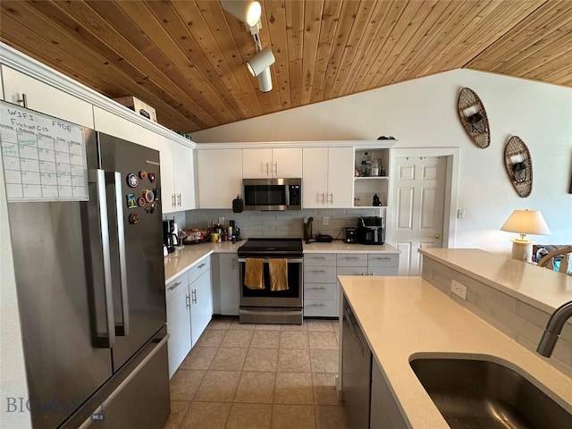 120 Firelight Dr Unit C15, Big Sky, MT 59716 - kitchen with stainless steel appliances, vaulted ceiling, a sink, wood ceiling, and tasteful backsplash