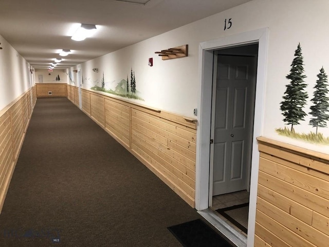 120 Firelight Dr Unit C15, Big Sky, MT 59716 - corridor with a wainscoted wall, dark colored carpet, and wooden walls