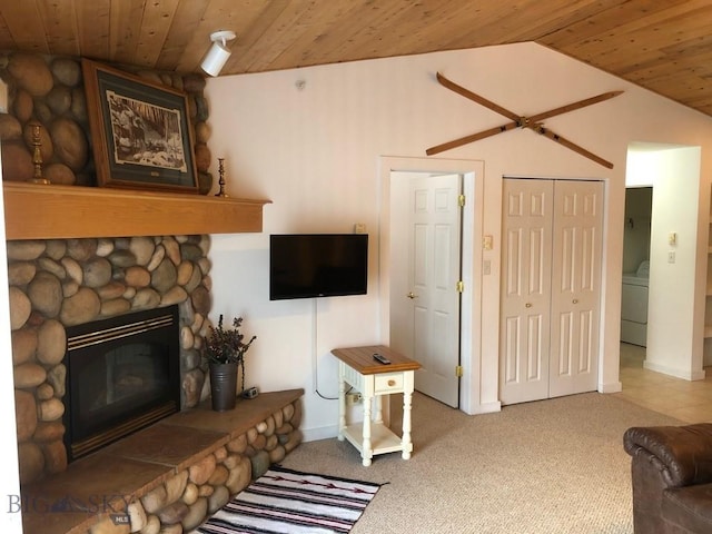 120 Firelight Dr Unit C15, Big Sky, MT 59716 - living area with wood ceiling, lofted ceiling, carpet floors, washer / dryer, and a stone fireplace