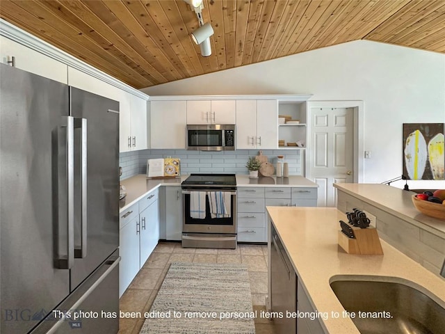 120 Firelight Dr Unit C15, Big Sky, MT 59716 - kitchen featuring stainless steel appliances, lofted ceiling, wooden ceiling, tasteful backsplash, and light countertops