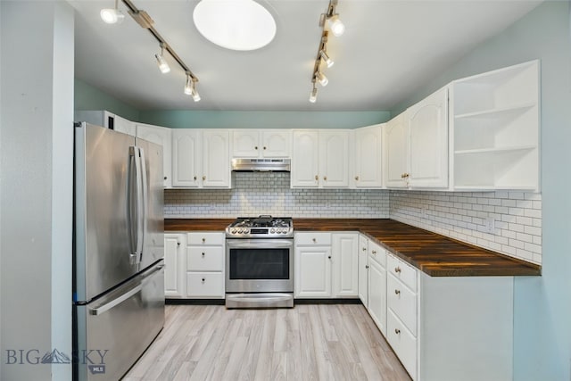 1205 Brentwood, Bozeman, MT 59718 - kitchen with stainless steel appliances, wood counters, under cabinet range hood, light wood-style flooring, and white cabinets