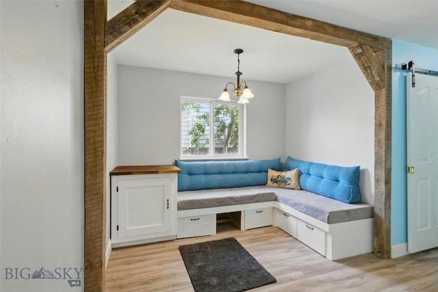 1205 Brentwood, Bozeman, MT 59718 - living area with a barn door, light wood finished floors, and a chandelier