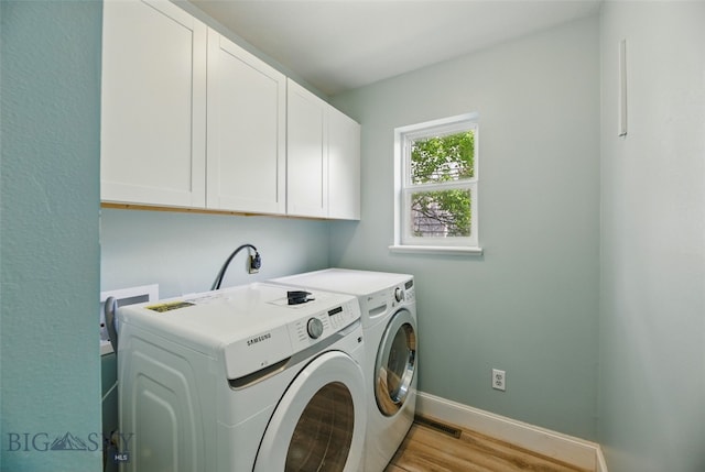 1205 Brentwood, Bozeman, MT 59718 - washroom featuring cabinet space, independent washer and dryer, light wood finished floors, and baseboards