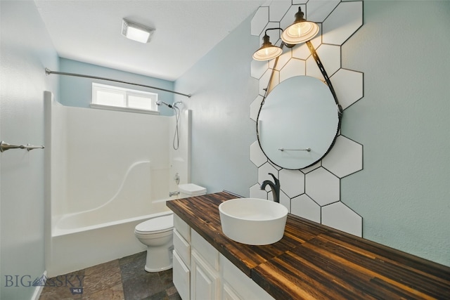 1205 Brentwood, Bozeman, MT 59718 - full bath featuring toilet, vanity, bathtub / shower combination, and stone finish flooring
