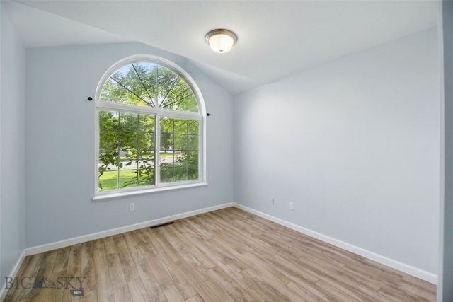 1205 Brentwood, Bozeman, MT 59718 - empty room featuring healthy amount of natural light, light wood finished floors, baseboards, and vaulted ceiling