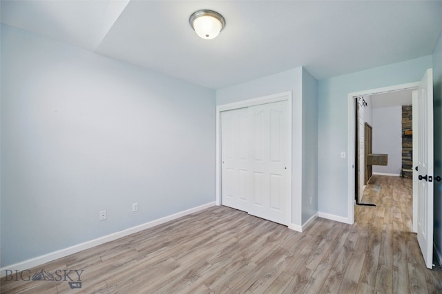 1205 Brentwood, Bozeman, MT 59718 - unfurnished bedroom with wood finished floors, baseboards, and a closet