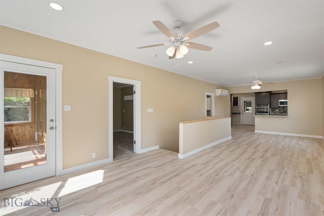 411 W 7th St, Anaconda, MT 59711 - unfurnished living room featuring ceiling fan, light wood finished floors, baseboards, a wall mounted AC, and recessed lighting