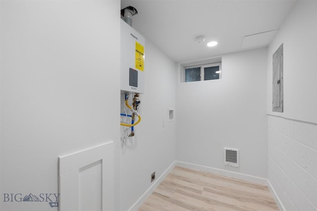 411 W 7th St, Anaconda, MT 59711 - laundry area featuring hookup for a washing machine, light wood-type flooring, heating unit, electric water heater, and electric panel