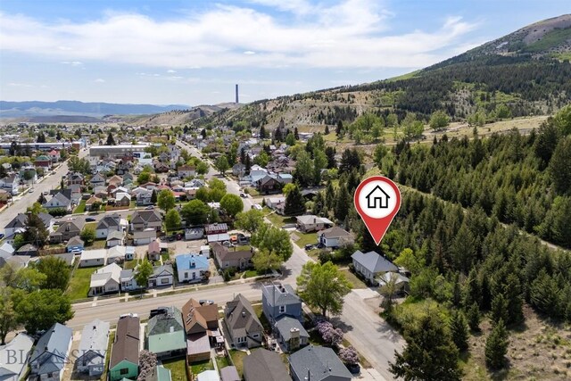 411 W 7th St, Anaconda, MT 59711 - aerial view of property's location featuring a mountainous background, a forest, and nearby suburban area