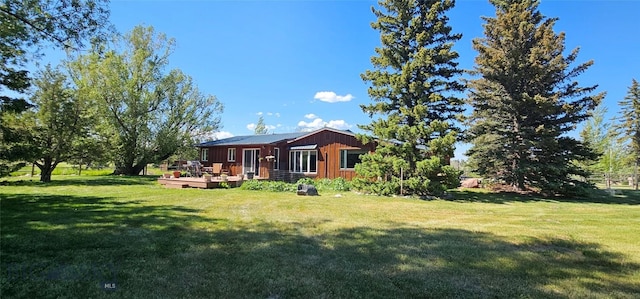 13 Shefield Dr, Ennis, MT 59729 - rear view of property with a deck, a yard, and board and batten siding