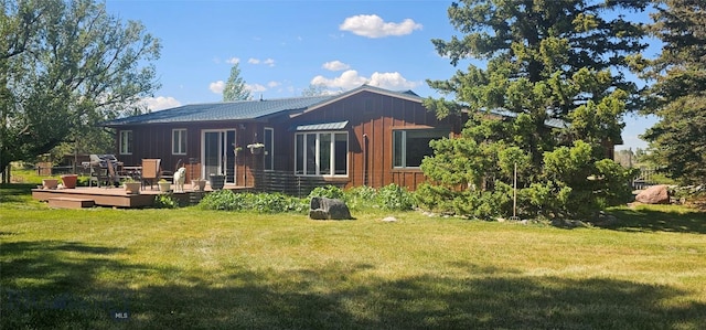13 Shefield Dr, Ennis, MT 59729 - back of property featuring board and batten siding, a wooden deck, and a lawn