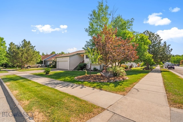 404 Flathead Ave, Bozeman, MT 59718 - view of front facade featuring a front yard, concrete driveway, and a garage