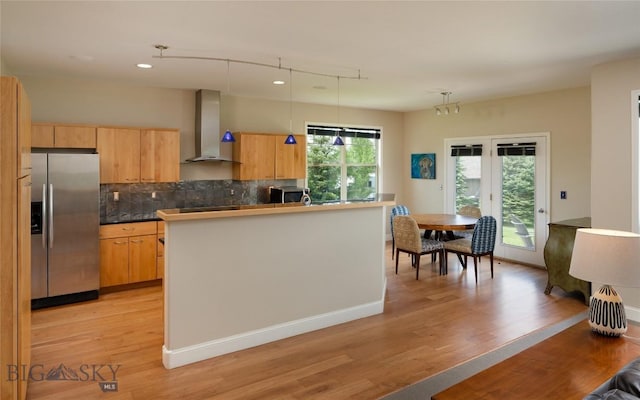 15 Blue Grouse Ct, Bozeman, MT 59715 - kitchen with appliances with stainless steel finishes, wall chimney exhaust hood, tasteful backsplash, light wood-style floors, and recessed lighting
