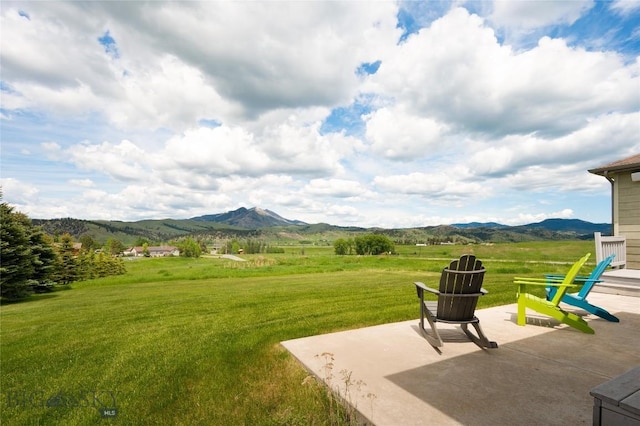 15 Blue Grouse Ct, Bozeman, MT 59715 - view of grassy yard with a patio area and a mountain view