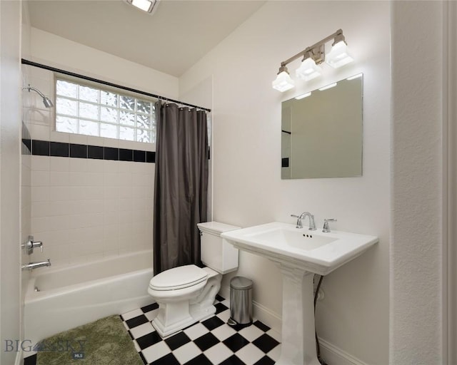 15 Blue Grouse Ct, Bozeman, MT 59715 - bathroom with tile patterned floors, shower / bath combo with shower curtain, toilet, and baseboards