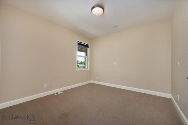 15 Blue Grouse Ct, Bozeman, MT 59715 - unfurnished room with dark colored carpet and baseboards