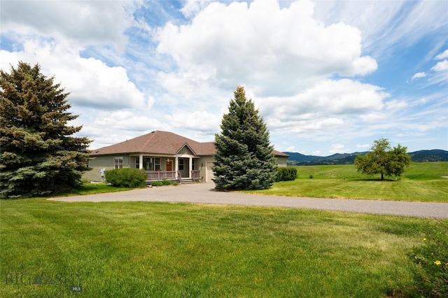 15 Blue Grouse Ct, Bozeman, MT 59715 - view of front facade featuring driveway, a front lawn, and a garage