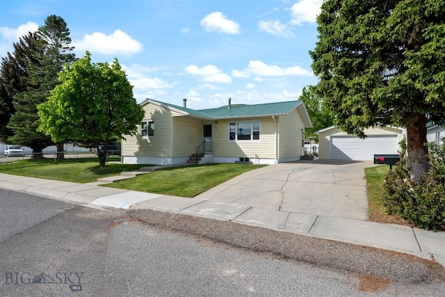 303 Sharon Ct, Anaconda, MT 59711 - view of front of property featuring an outbuilding, a detached garage, a front yard, and metal roof