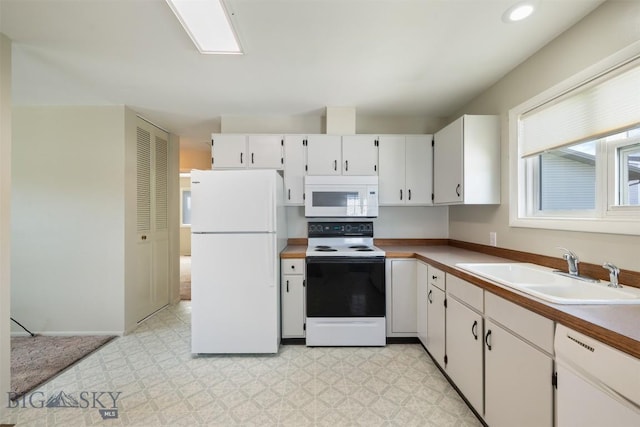 303 Sharon Ct, Anaconda, MT 59711 - kitchen featuring white appliances, a sink, light floors, and white cabinetry