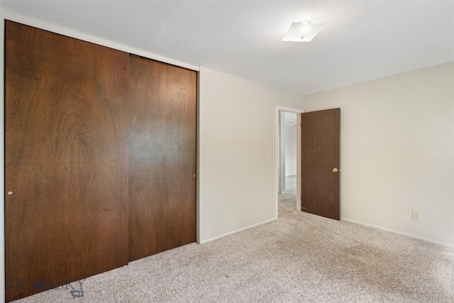 303 Sharon Ct, Anaconda, MT 59711 - unfurnished bedroom with a closet, carpet floors, and baseboards