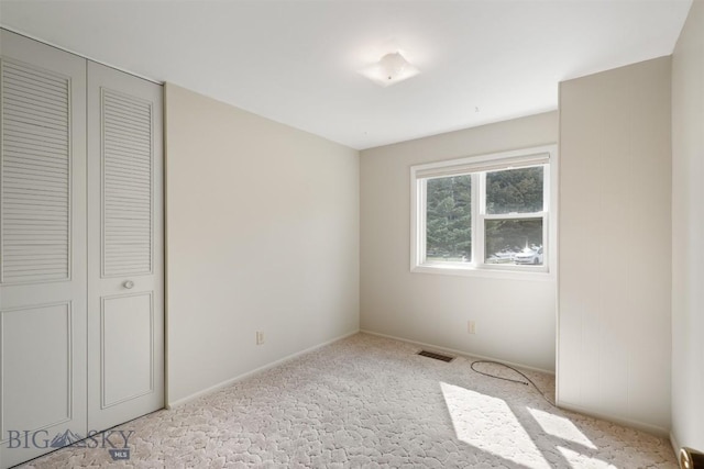 303 Sharon Ct, Anaconda, MT 59711 - unfurnished bedroom with light carpet, a closet, and baseboards