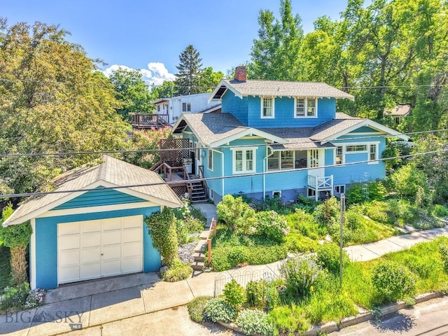 602 S 6th Ave, Bozeman, MT 59715 - view of front of home with stairs, driveway, a chimney, a garage, and a shingled roof